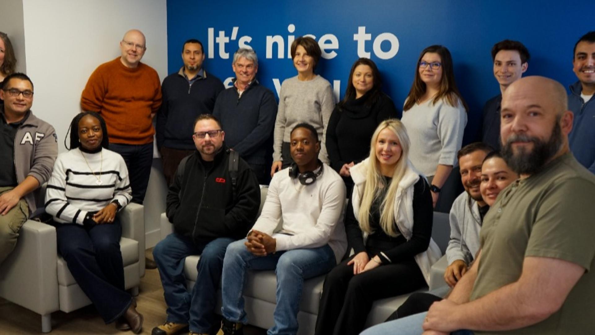 Entrepreneurs sitting at DMZ smiling for photo
