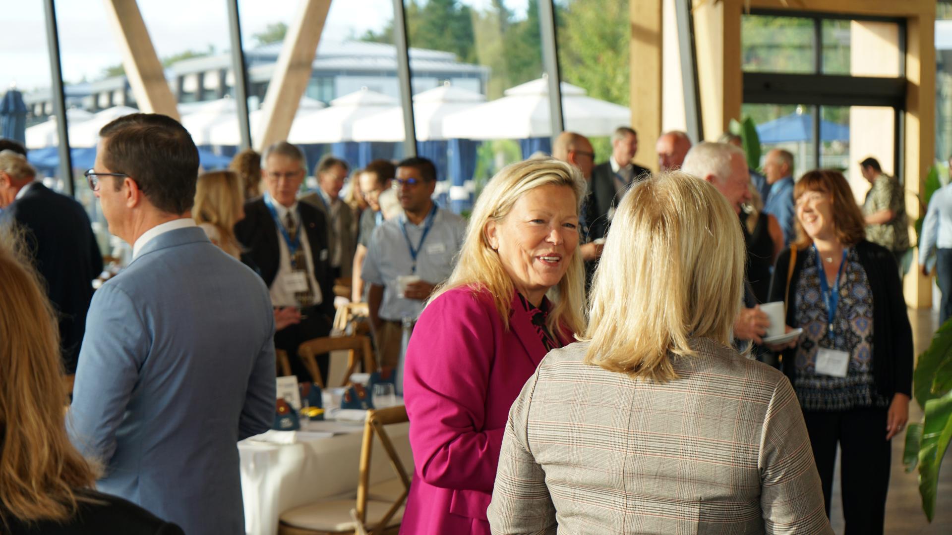 Mayor Lynn Dollin talking with an event attendee at the Mayor's Business Breakfast