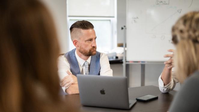 Man in suit looking at coworker