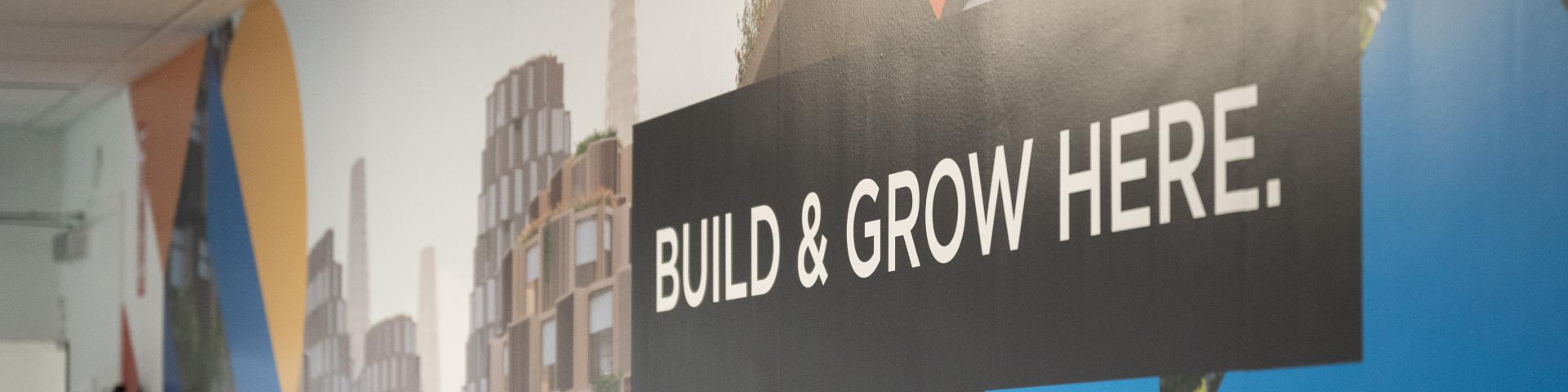 Build & Grow Here wall mural at the DMZ Innisfil office