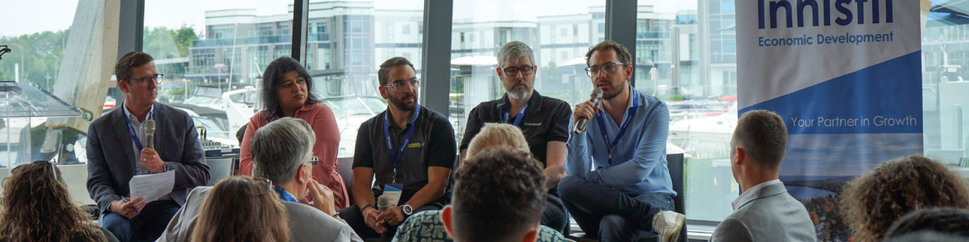 Panel of entrepreneurs speaking to a crowd of people