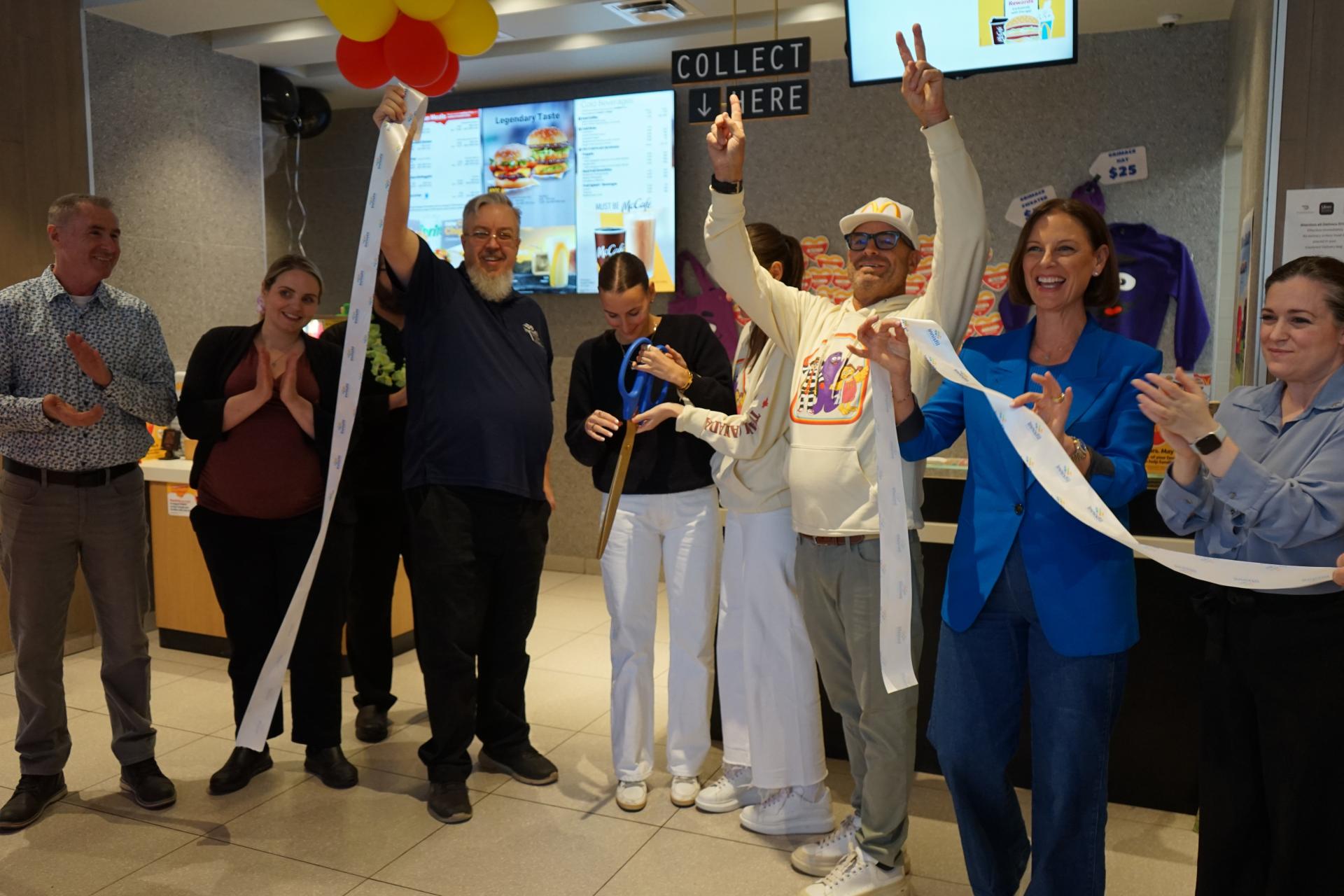 Crowd celebrating at the ribbon cutting ceremony of the Cookstown McDonalds grand opening